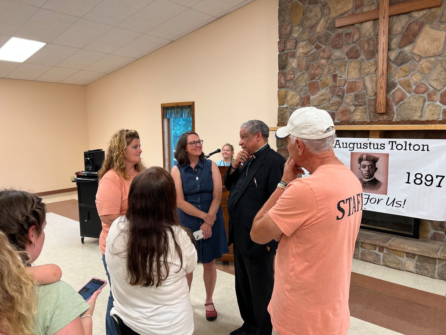 Auxiliary Bishop Joseph N. Perry of Chicago, postulator for the sainthood cause of Venerable Father Augustus Tolton, visits with adults during Camp Tolton at Camp Jo’Ota in Clarence.